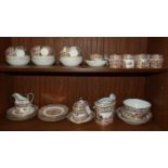 A 19th century English porcelain part tea service decorated with gilt and coloured panels of flowers