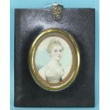 19th century, an oval miniature portrait of a young lady wearing a white lace-trimmed dress,