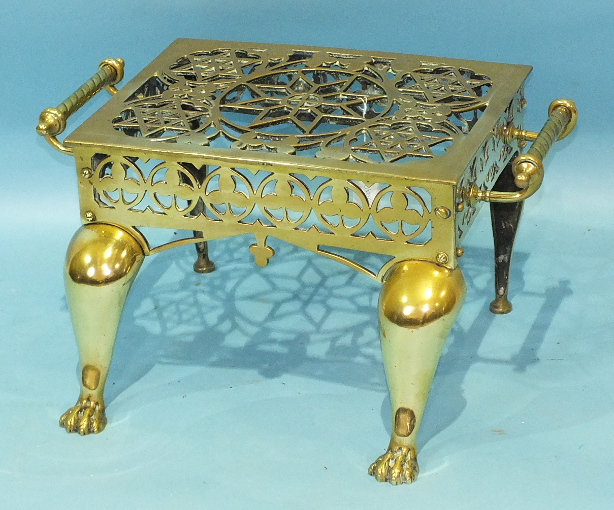 A brass two-handled footman with pierced top, on cabriole legs and paw feet, 54cm wide, 29cm high, - Image 2 of 3