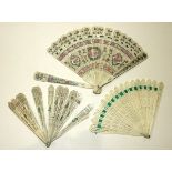 A bone brisé fan, the pierced guards and blades with painted and silvered decoration, 32 x 18cm