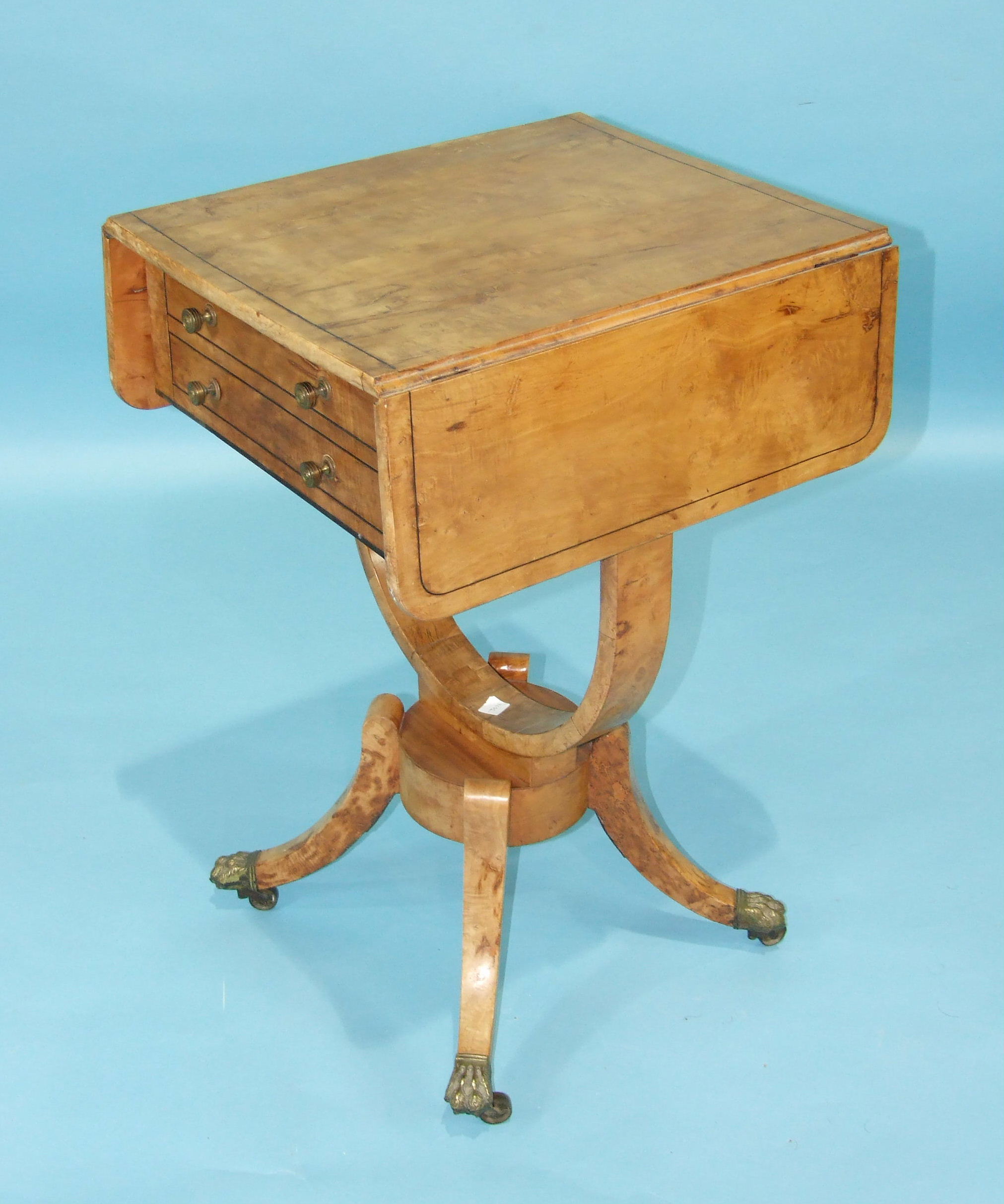 An early-19th century maple-veneered work table, the rectangular top with two drop leaves above