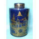 A large Chinese porcelain tea canister and lid decorated with gilt landscape scenes on a deep blue