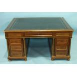An Empire-style mahogany partner's desk with overall brass mouldings, the rectangular top above