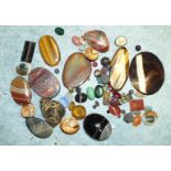 A quantity of cut and loose polished stones including tigers eye, agates, operculae and pastes.