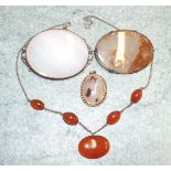 A sterling silver necklace with cornelian drop and beads, two agate set brooches and an agate set