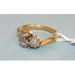 A diamond cross over ring set two brilliant cut diamonds in 18ct gold mount, size M, 3.6g.