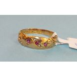 An 18ct gold gypsy ring set three round cut rubies with rose cut diamond points between, size N,