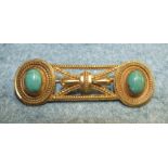 An unusual Victorian yellow metal brooch set two turquoise coloured stones in the Etruscan Revival