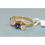 A sapphire and diamond ring claw set two brilliant cut diamonds and a round cut sapphire in 18ct