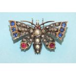 A late Victorian diamond, sapphire, ruby and pearl set butterfly brooch, the thorax and abdomen