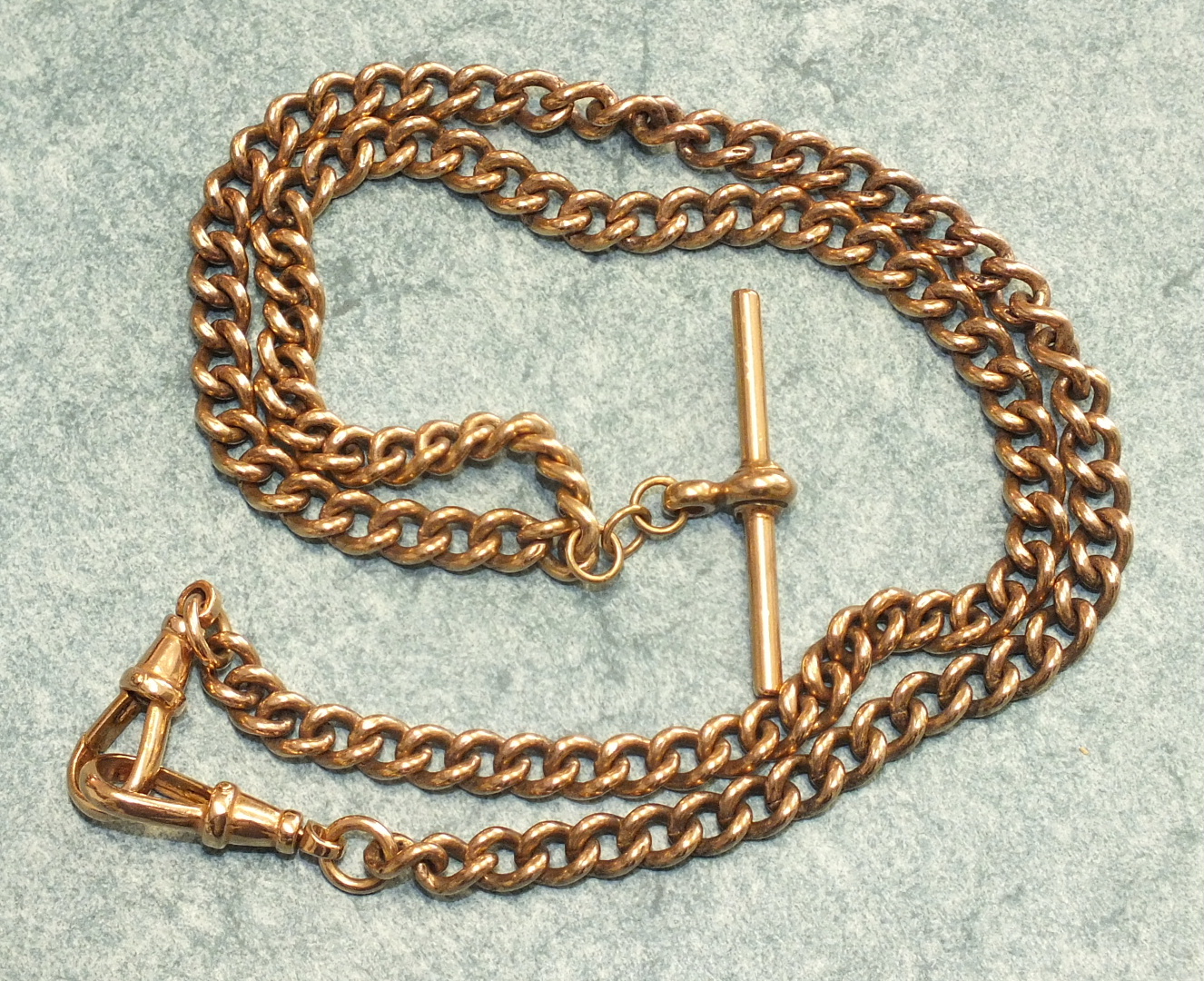 A 9ct rose gold curb link chain, all links marked 375 with unmarked yellow metal shackles and T-bar,