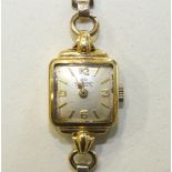 Bucherer a ladies square faced 18ct gold cased wrist watch on gold plated bracelet.