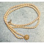 A cultured pearl choker of two strings of uniform pearls to 9ct gold cultured pearl set clasp,