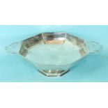 An octagonal silver fruit dish, two sides extended and pierced to form handles, by Walker & Hall,