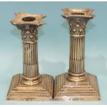 A pair of loaded Corinthian column short candlesticks complete with beaded sconces, 15.5cm high,