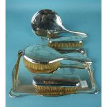 A silver dressing table set, comprising a shaped rectangular galleried tray, a hand mirror, 30 x