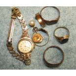 Three 9ct gold signet rings, another, unmarked, a 9ct gold cased wrist watch on plated bracelet