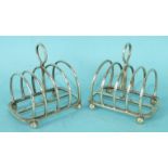 A pair of Harrods Ltd miniature silver four division toast racks on ball feet, maker R W