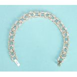 An Art Deco style bracelet of open bar and chevron links and concealed clasp, set throughout with