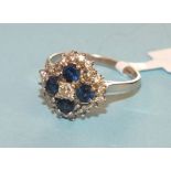 A sapphire and diamond cluster ring claw set a brilliant cut diamond and four round cut sapphires