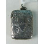 A silver vesta case with engraved scrolling decoration, Chester 1898.