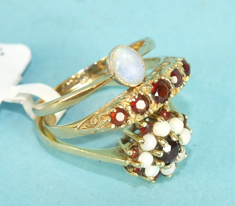 A five stone garnet 9ct gold ring, size O 1/2, a 9ct gold opal and garnet cluster ring, size N and a