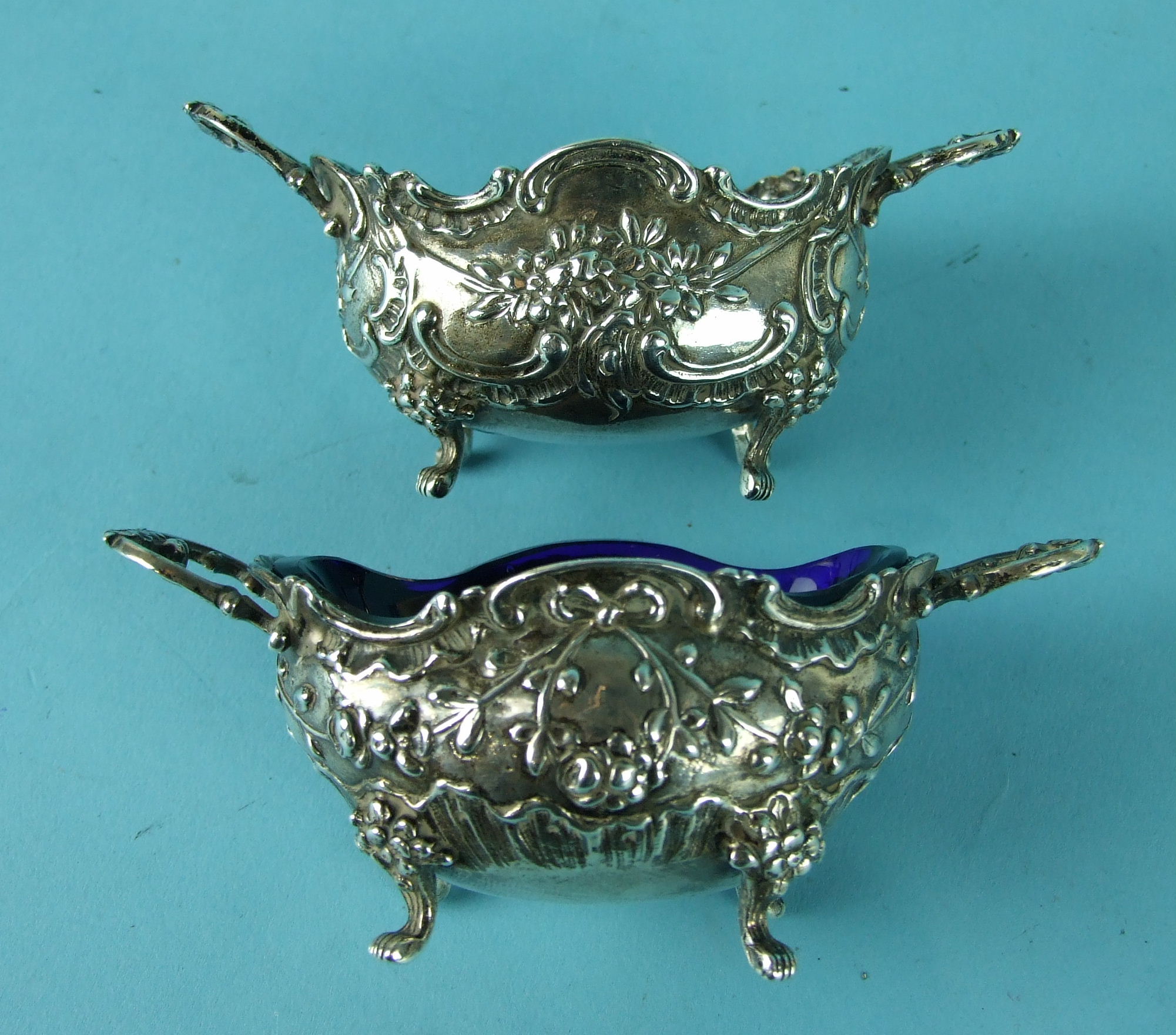 A pair of Continental oval cast two-handled salts on short cabriole legs with paw feet, 12cm, import