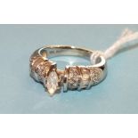 A diamond ring claw set a marquise cut diamond between shoulders set with bands of 8/8 and