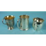 A plain cylinder-shaped christening tankard, London 1929 and two others, ___10oz.