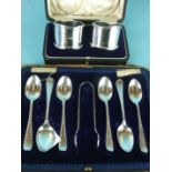 A cased pair of silver napkin rings with reeded wavy rims, Birmingham 1912 and a set of six