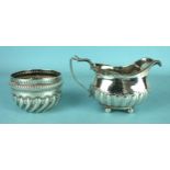 A late Victorian silver porringer with gadrooned decoration, Chester 1898 and a silver cream jug,