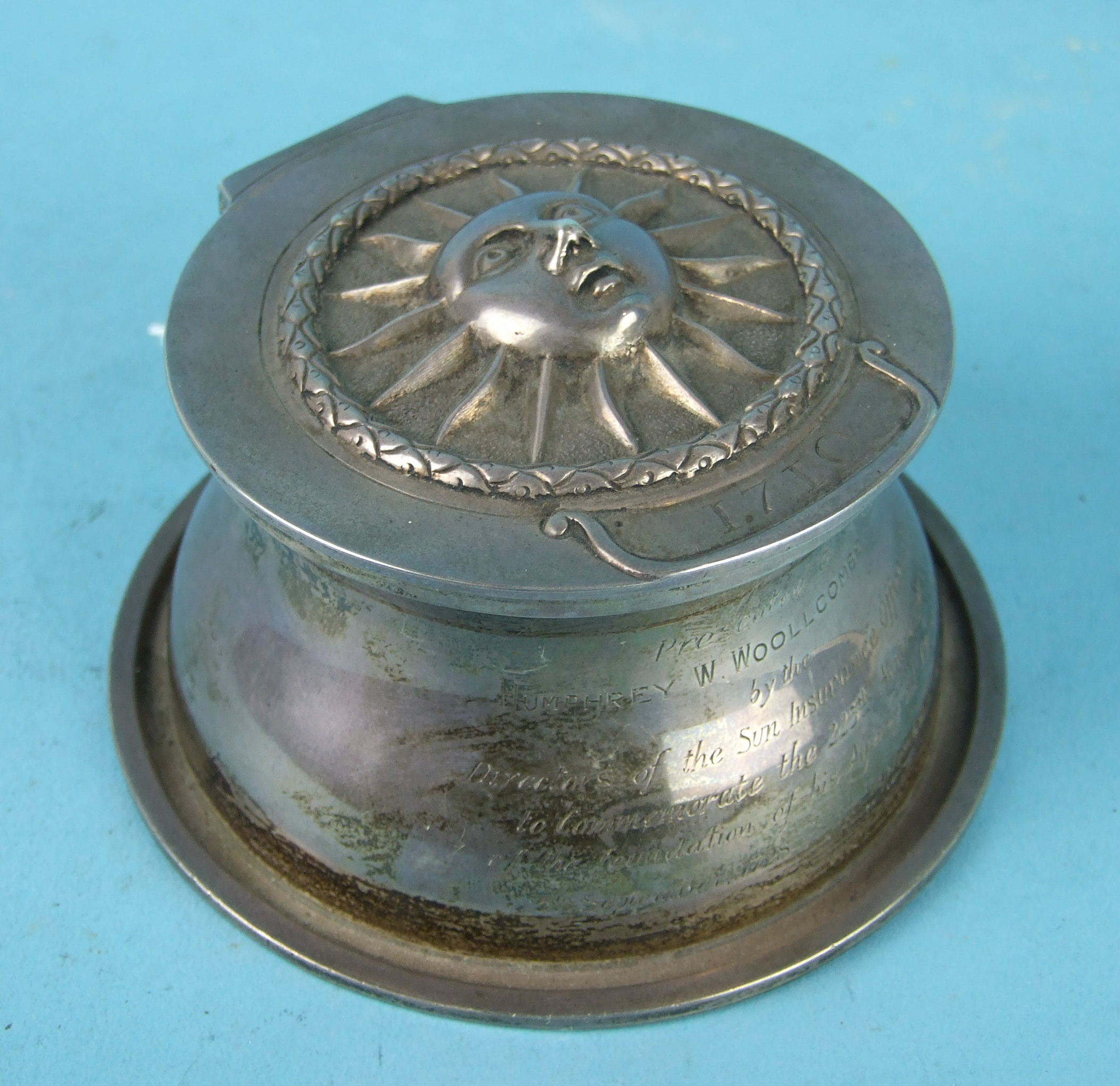 A Sun Insurance commemorative silver inkwell, the hinged lid with embossed sun mask above the date