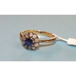 A sapphire and diamond cluster ring set ten old brilliant cut diamonds around a round cut sapphire