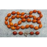 A single string necklace of uniform butterscotch amber beads, each approximately 14 x 10mm, 33.7g