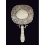 A Chinese jade mounted hand mirror with belt hook handle carved with a dragon and dragon head, the