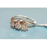 A three stone diamond ring, the claw set brilliant cut diamonds totalling 1 ct and set in 18ct white