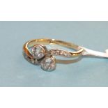 A diamond cross over ring, collet set two old brilliant cut diamonds on 18ct gold mount set 8/8