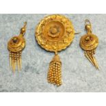 A Victorian gilt metal brooch with applied and cast decoration and tassel below and a pair of