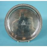 A small George III silver salver with gadrooned rim and raised on three cast feet, 17.7cm