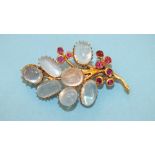 A moonstone and ruby spray brooch, claw set seven moonstones and nine collet set rubies in