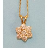 A seven stone diamond cluster pendant, the brilliant cut diamonds of approx 0.16st each, claw set in