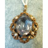 A 9ct gold pendant set a large blue spinel of approximately 18cts and four culture pearls, 4cm long,