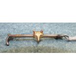 A 9ct gold and silver bar brooch in the form of a riding crop with fox's mask to centre, 5.1cm, 2.