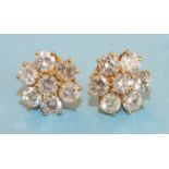 A pair of diamond flower head cluster ear studs, each claw set seven brilliant cut diamonds of