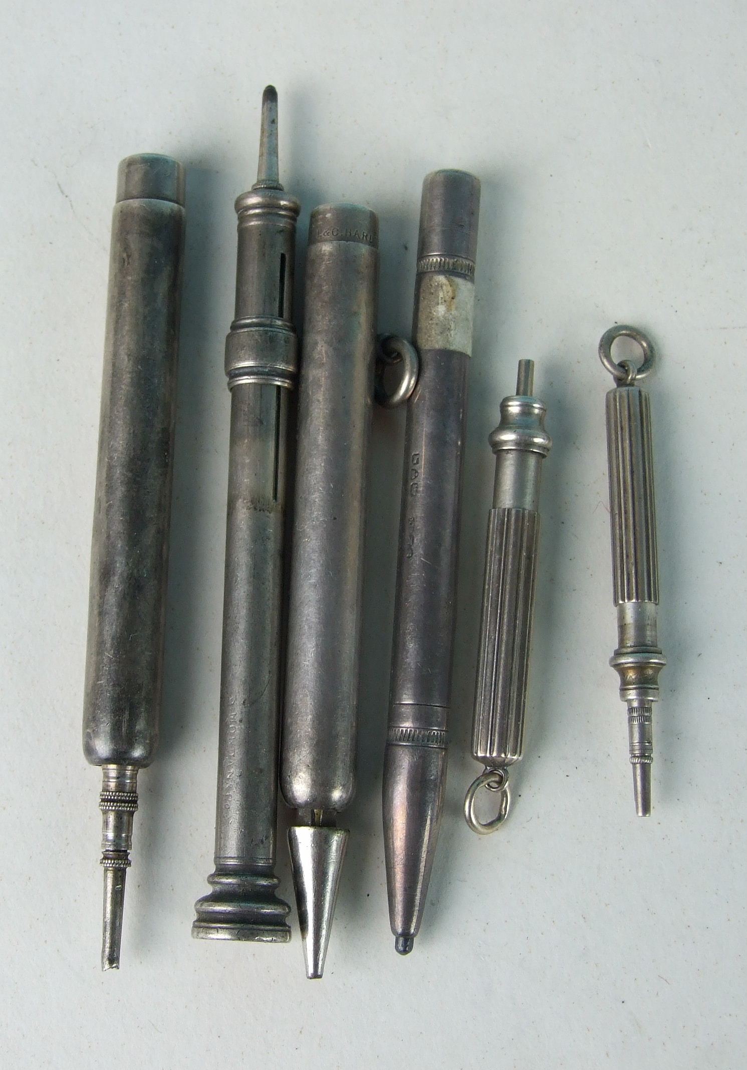 Five S Mordan & Co propelling pencils (three af), and one L & C Hardtmuth's Koh-i-Nor silver pencil,