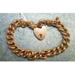 A 15ct rose gold hollow curb link bracelet with padlock clasp, 20.5cm long.