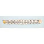 A moonstone bracelet, of three rows of graduated round moonstones, all collet set in 9ct gold mounts