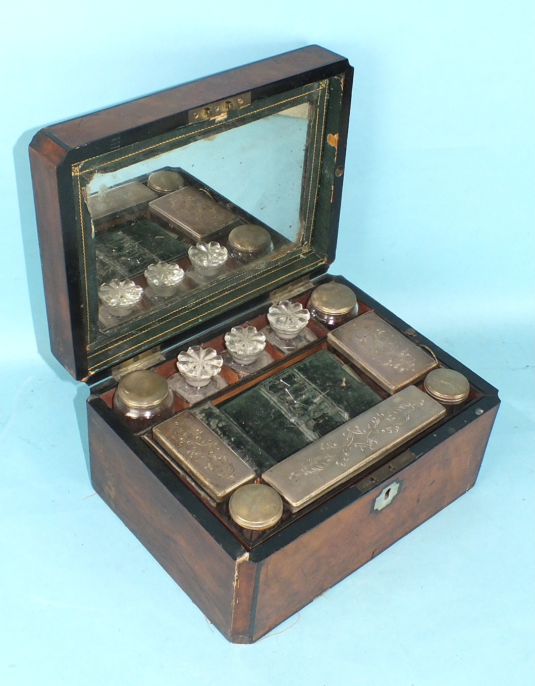 A Victorian ladies burr walnut dressing case fitted with seven plated-mount bottles and trinket