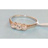 A three stone diamond ring, the old brilliant cut diamonds claw set in white metal mount, size O,
