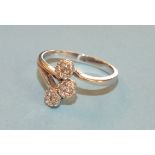 A 9ct white gold ring set three clusters of brilliant cut diamond points, size M½, 2.5g.